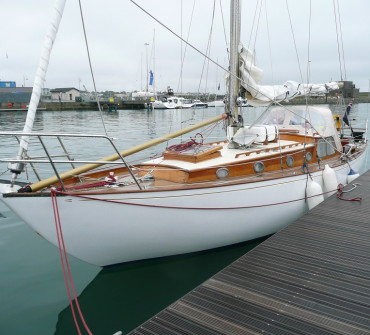 Wooden sailing yacht tied to a pontoon