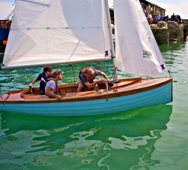 Wooden Sailing dinghy on the water