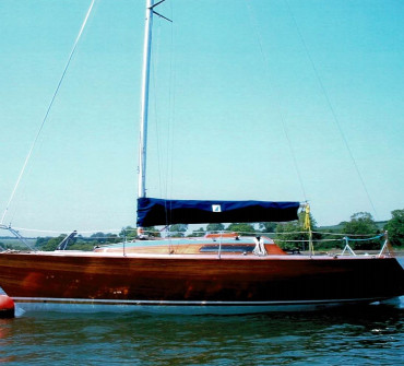 Varnished wooden racing yacht on a mooring