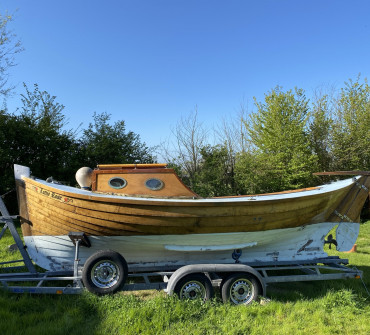Wooden clinker day boat on a trailer