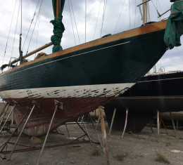 Classic teak sailing yacht out of the water