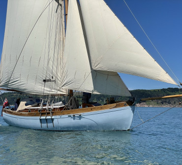 Wooden gaff cutter yacht under sail
